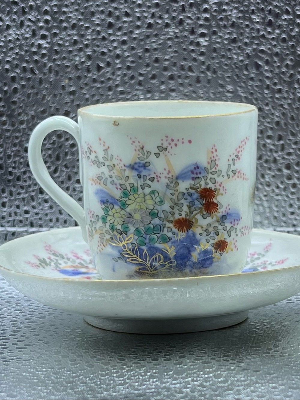White Floral Porcelain tea and saucer with Gold Trim